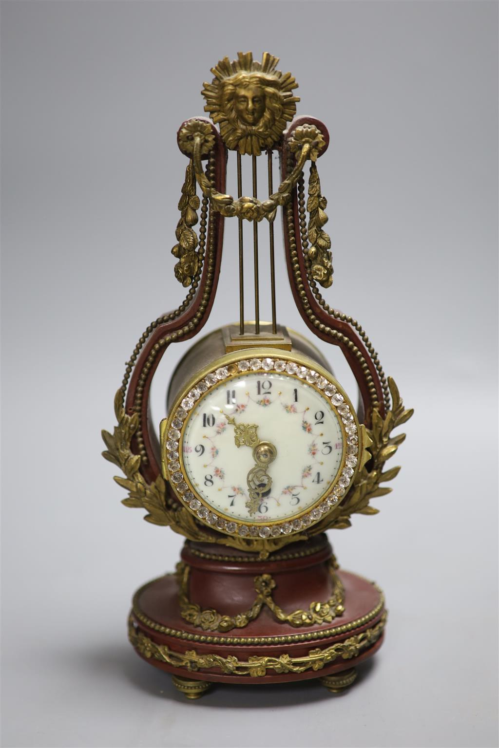 An early 20th century French lyre shaped mantel timepiece, with enamelled dial, height 26.5cm